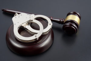 handcuffs and mallet on a table