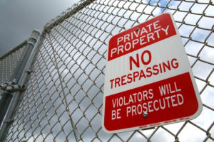 no trespassing sign on a fence